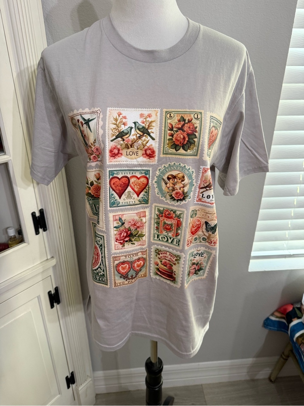 Vintage Stamp Graphic Tee - Light Gray with Floral & Heart Motifs
